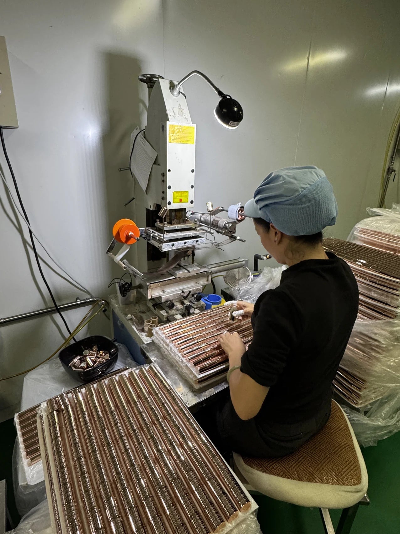 Operator working with cosmetic packaging components